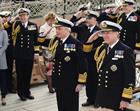 The new First Sea Lord Admiral Sir Philip Jones (centre) salutes on board HMS Victory