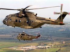 Merlin Mk3 helicopter in formation with a CHF Sea King Mk 4. 
