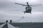 An 824 NAS Merlin Mk2 conducts helicopter inflight refuelling with HMS Prince of Wales deck